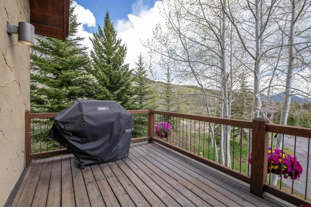 a view of balcony with wooden floor and outdoor seating
