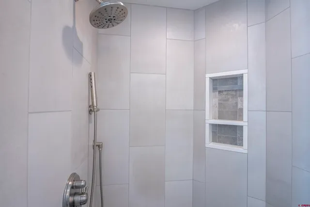 a bathroom with a shower and a mirror