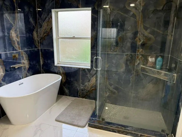 a bath tub sitting next to a shower