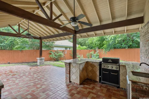 a view of a patio with a table and chairs under an umbrella with a couch