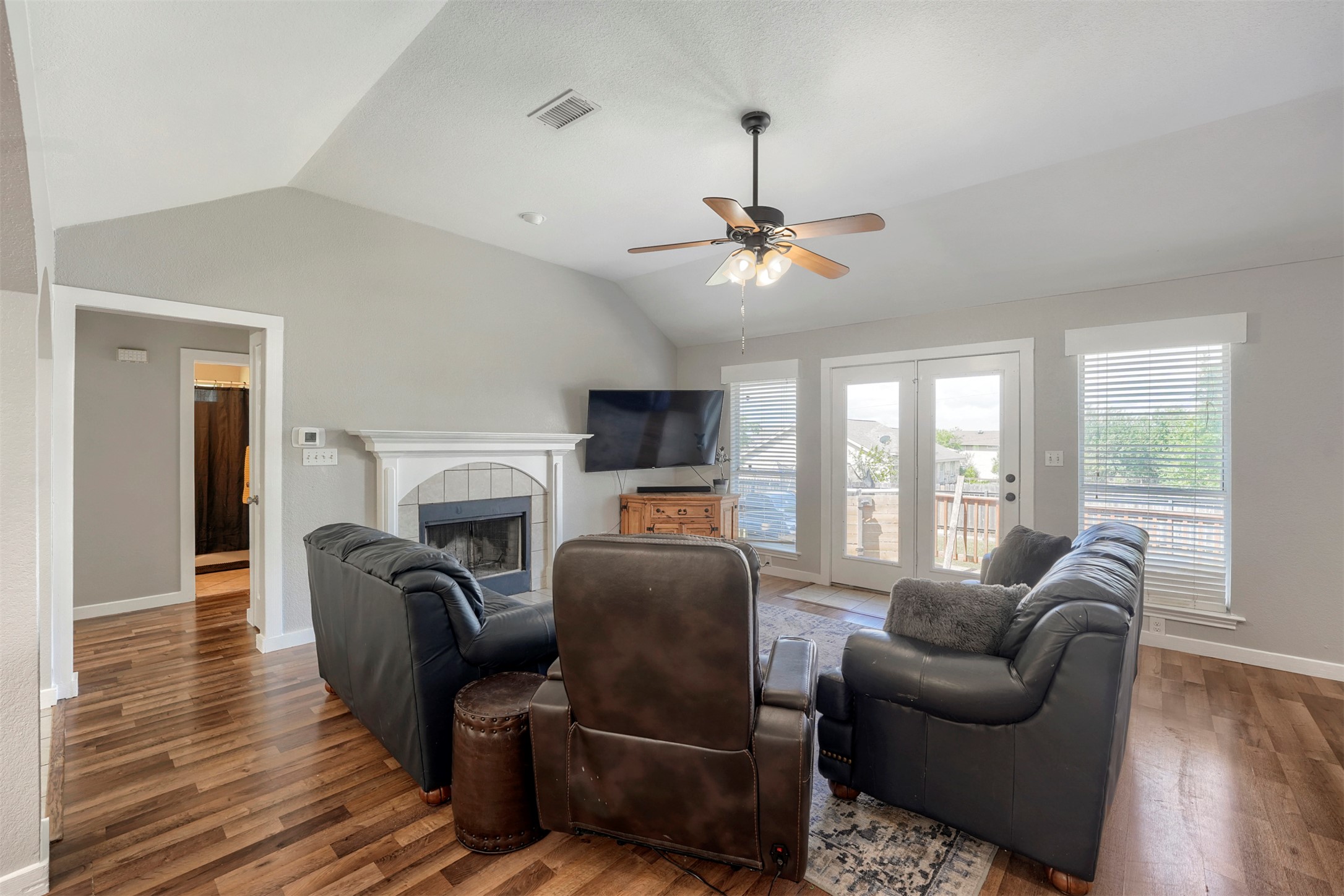 1105 2nd Street Jarrell, TX 76537 - Photo 5 of 27 A comforting living area with a fireplace and vaulted ceilings.