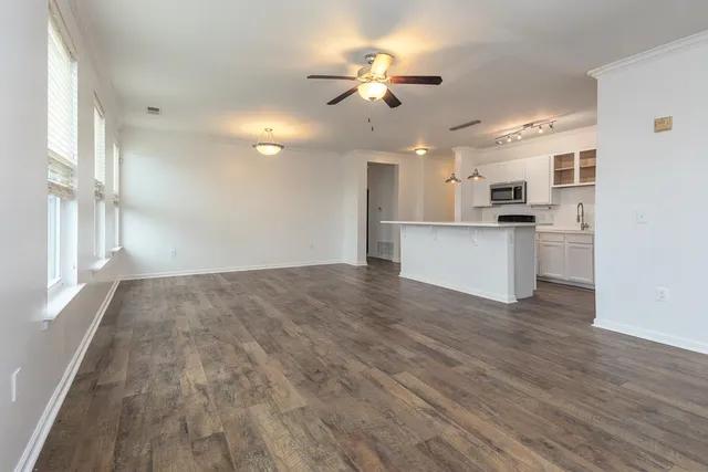 a view of a kitchen with a stove cabinets and wooden floor