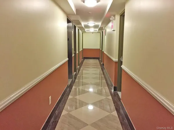 a view of a hallway with wooden floor and stairs