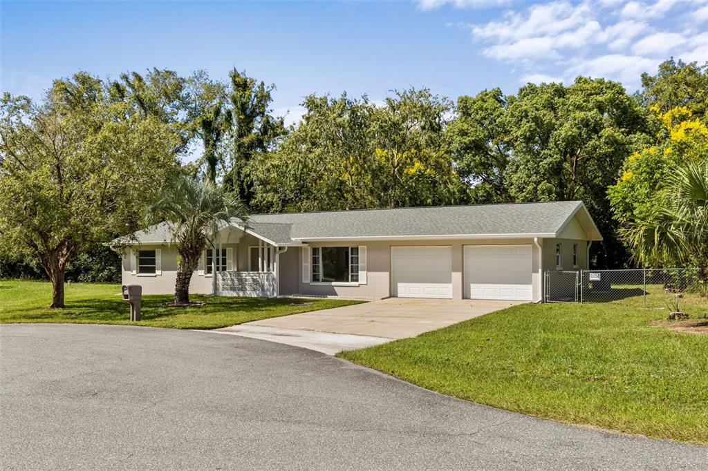 5 Silver Terrace Ocala, FL 34472 - Photo 1 of 1 a front view of a house with a garden and trees