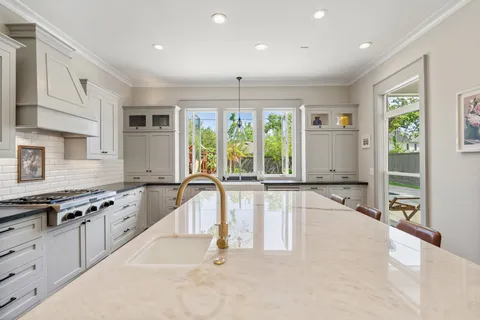 a kitchen with granite countertop a stove and a sink