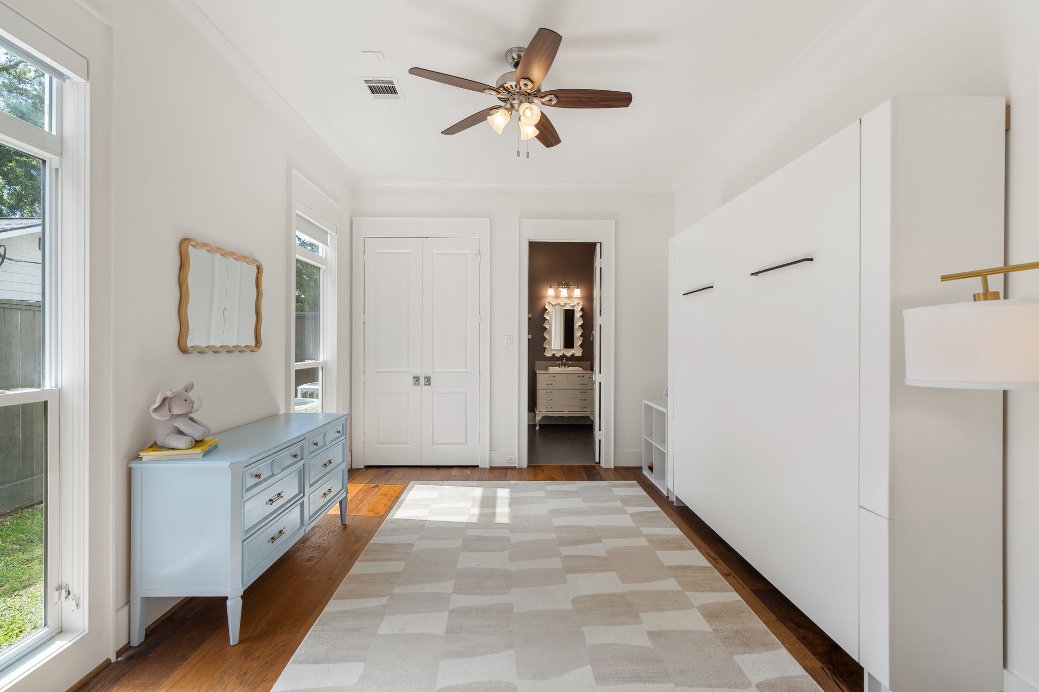 930 West 43rd Street Houston, TX 77018 - Photo 17 of 39 a view of a hallway with a chandelier fan and windows