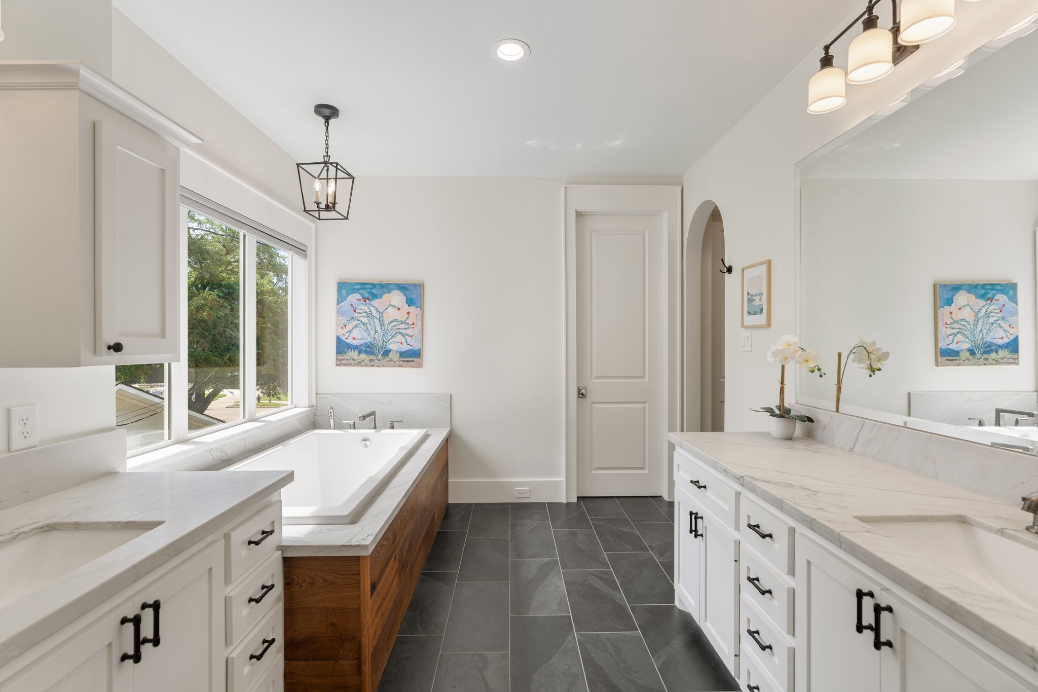 930 West 43rd Street Houston, TX 77018 - Photo 23 of 39 a spacious bathroom with a granite countertop double vanity sink a large mirror and a bathtub