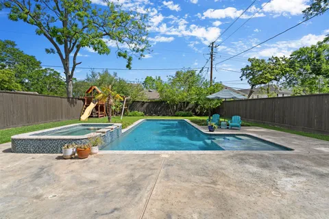 a backyard of a house with table and chairs