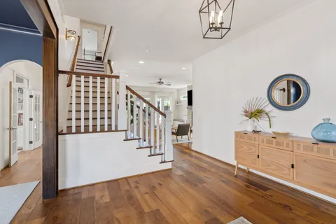 a view of a dining room with furniture wooden floor and chandelier