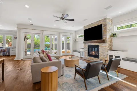 a living room with furniture a flat screen tv and a fireplace