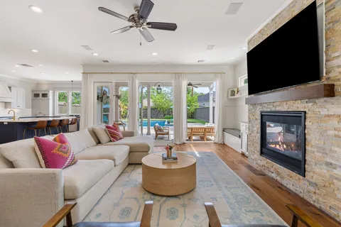 a living room with furniture a flat screen tv and a fireplace