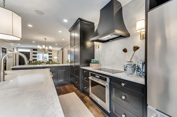 a kitchen with stainless steel appliances a sink stove and cabinets