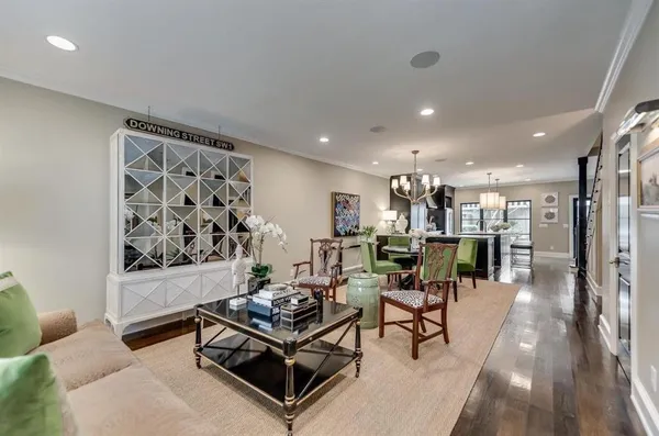 a living room with furniture and a painting on the wall