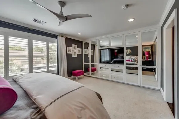 a large bedroom with a bed closet and a large window