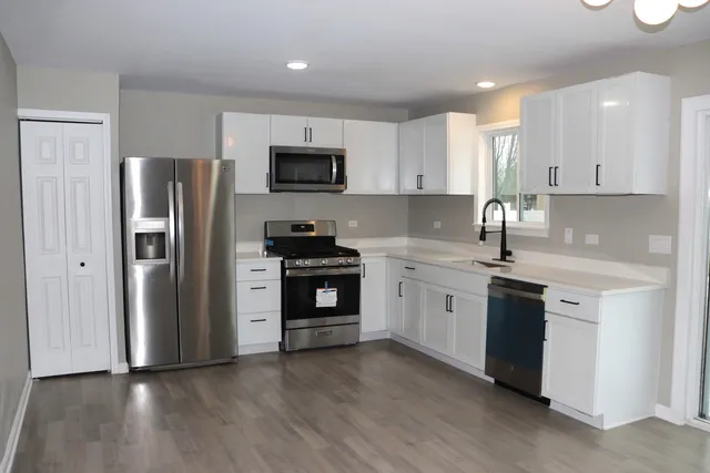 a kitchen with a refrigerator stove and microwave