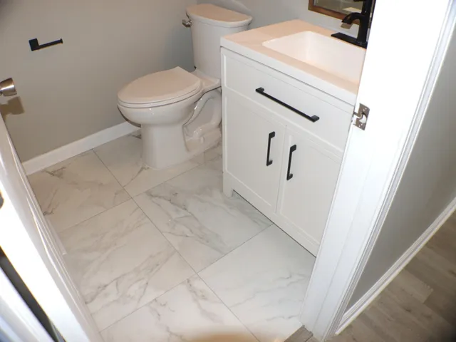 a bathroom with a toilet and a sink