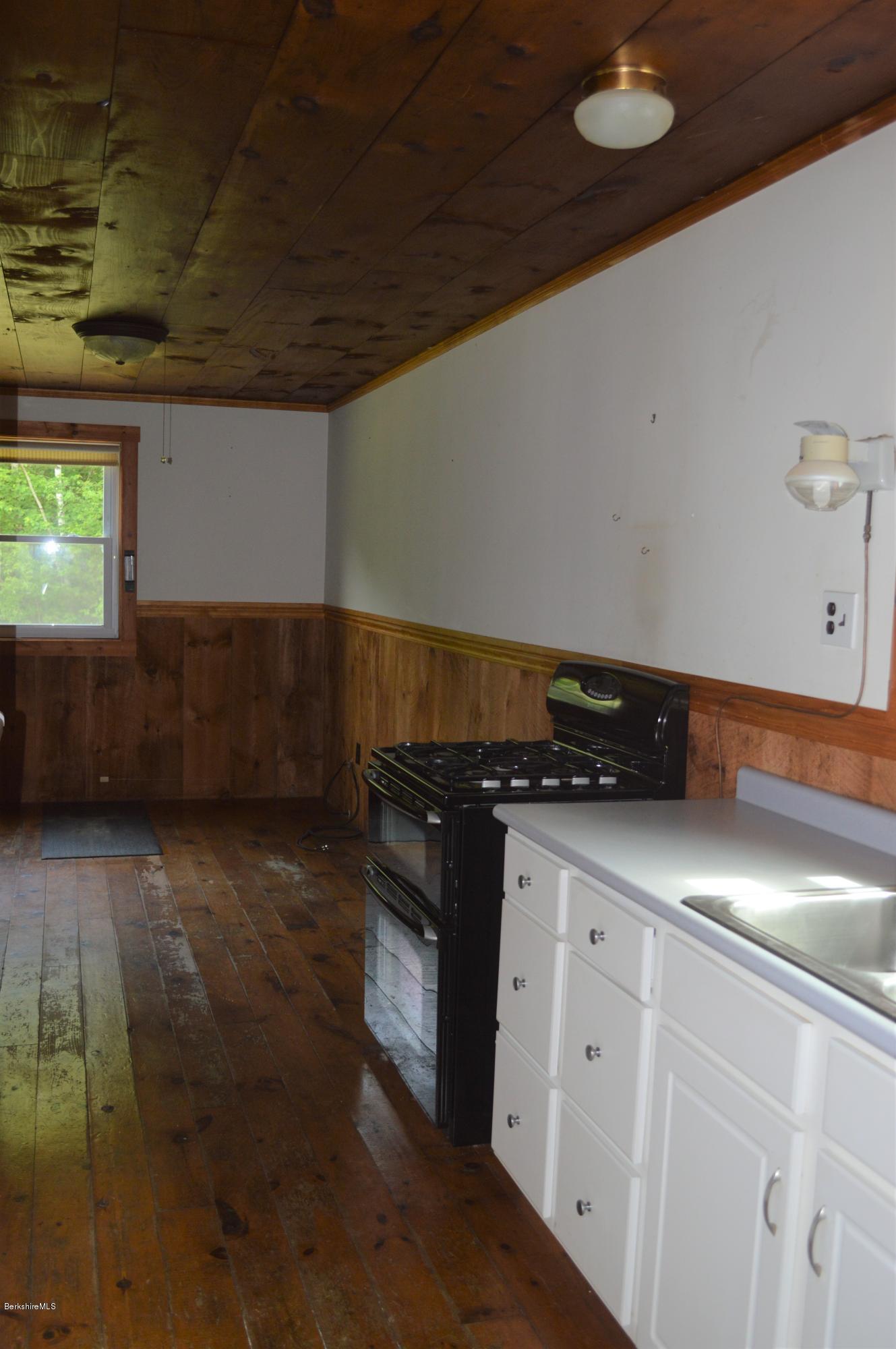 115 Webster Road Tyringham, MA 01264 - Photo 11 of 23 a kitchen with a sink and cabinets