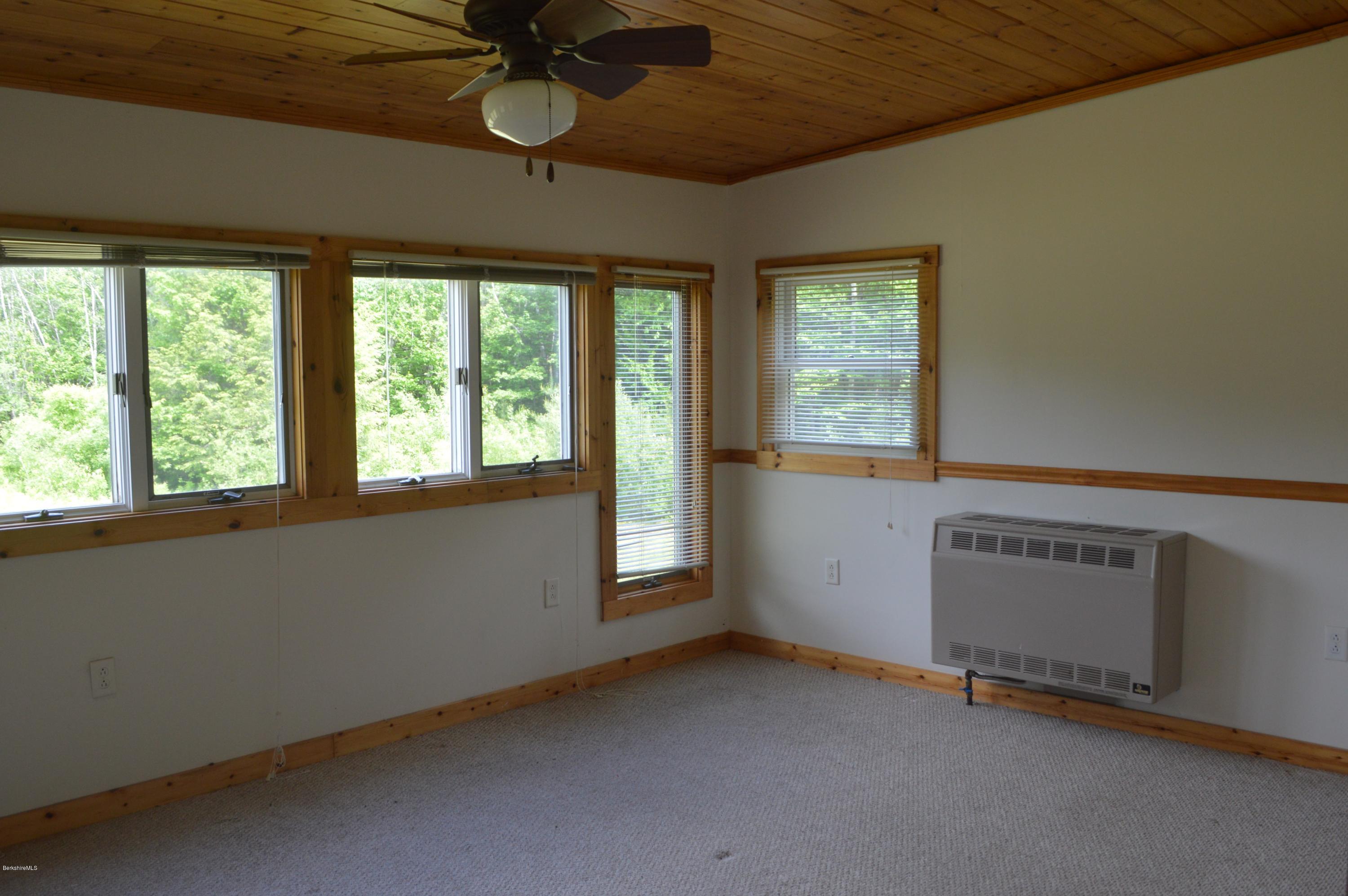 115 Webster Road Tyringham, MA 01264 - Photo 12 of 23 a view of an empty room with a window
