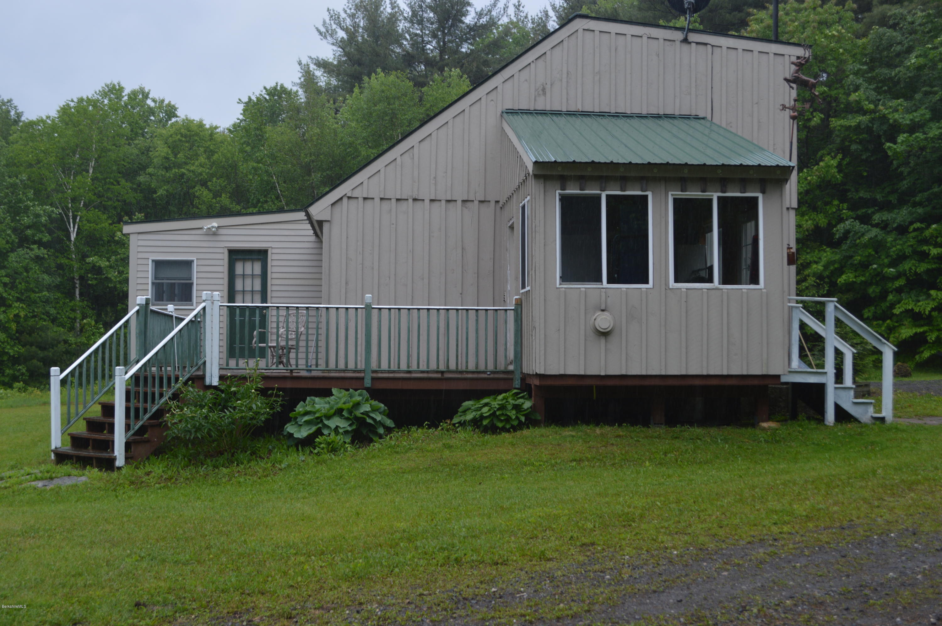 115 Webster Road Tyringham, MA 01264 - Photo 18 of 23 a view of a house with a yard and sitting area
