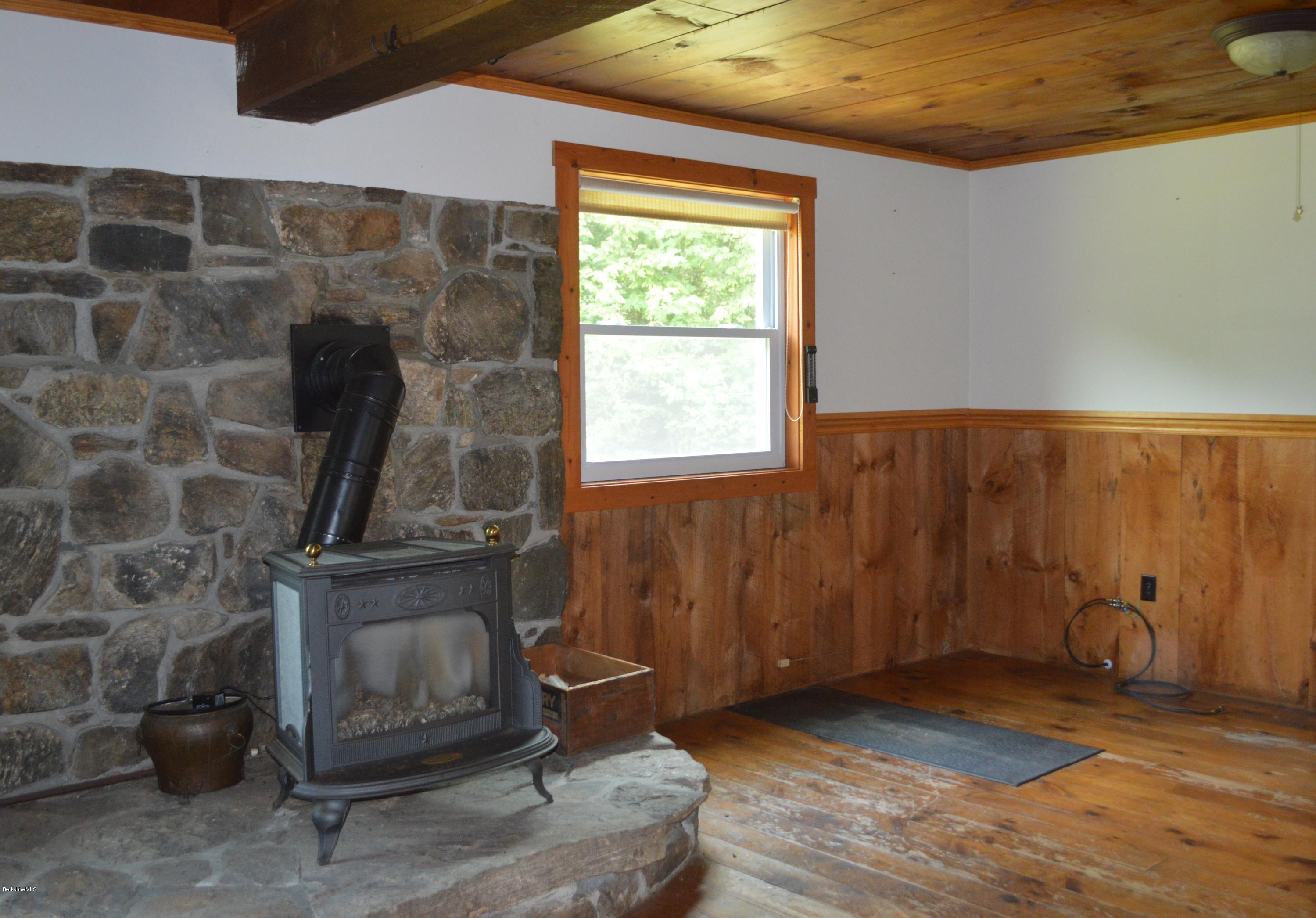 115 Webster Road Tyringham, MA 01264 - Photo 7 of 23 a living room with furniture and a fireplace