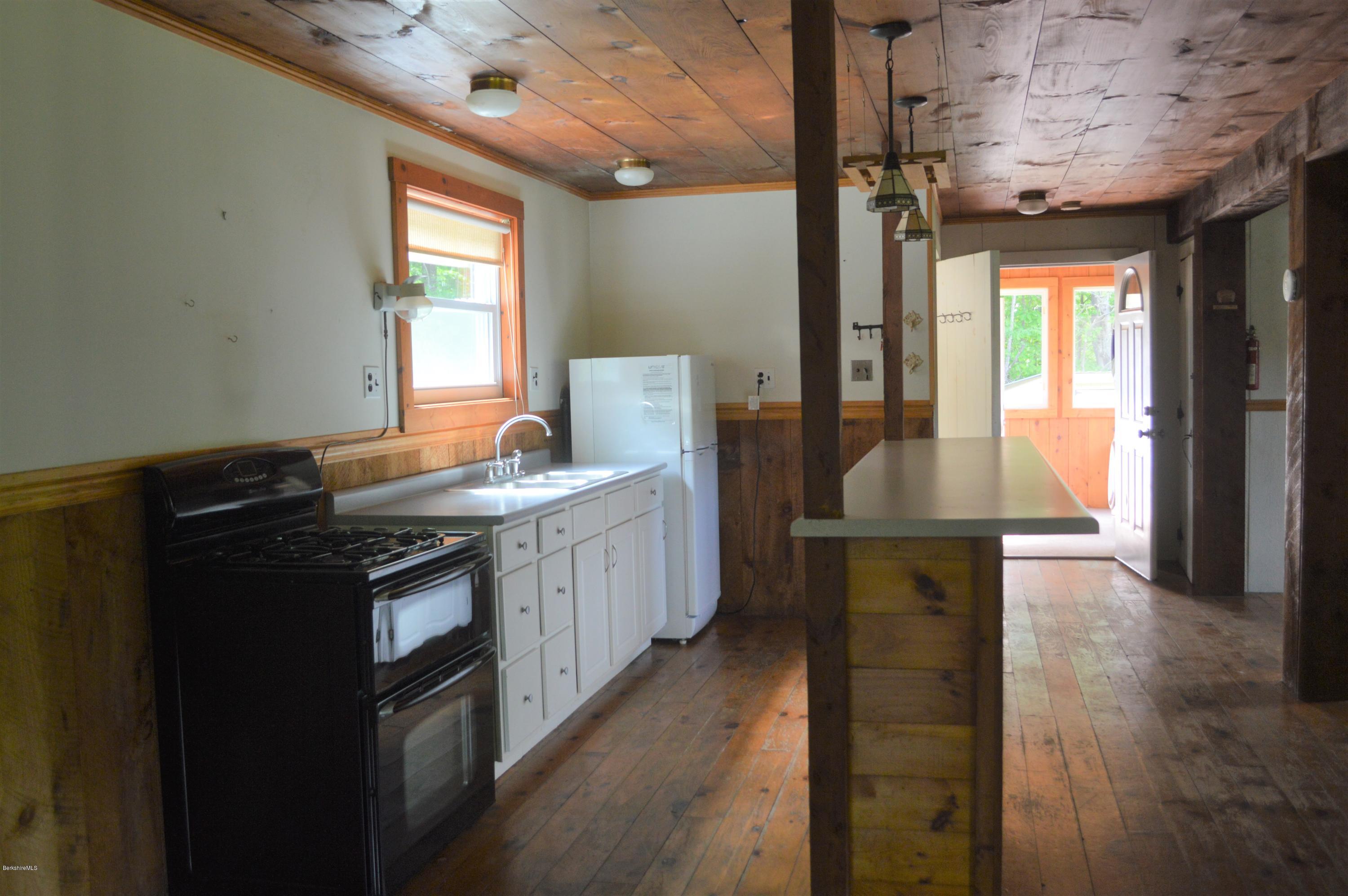 115 Webster Road Tyringham, MA 01264 - Photo 9 of 23 a kitchen with sink cabinets and outdoor view