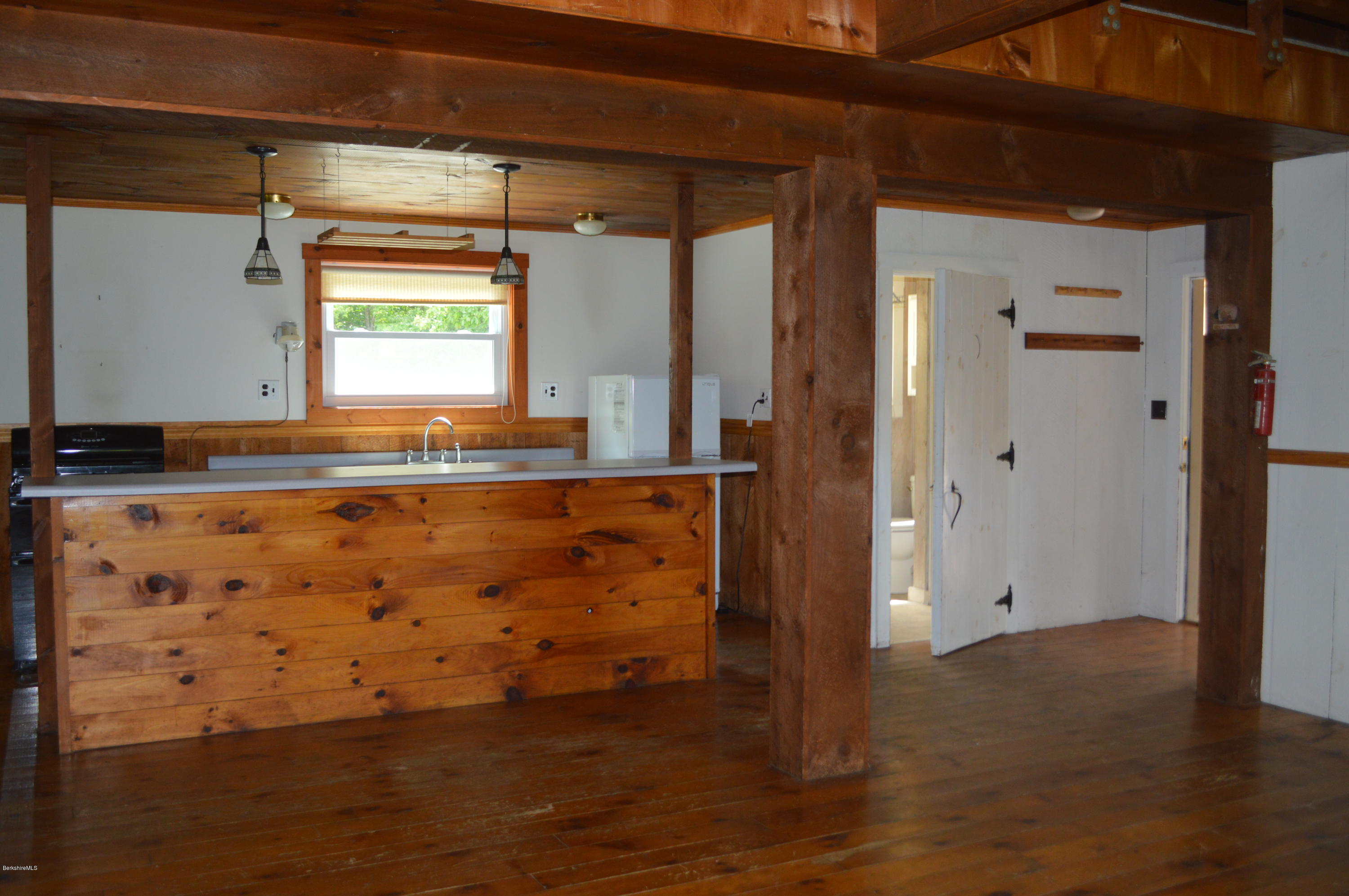 115 Webster Road Tyringham, MA 01264 - Photo 10 of 23 a view of kitchen with granite countertop wooden floor and white cabinet