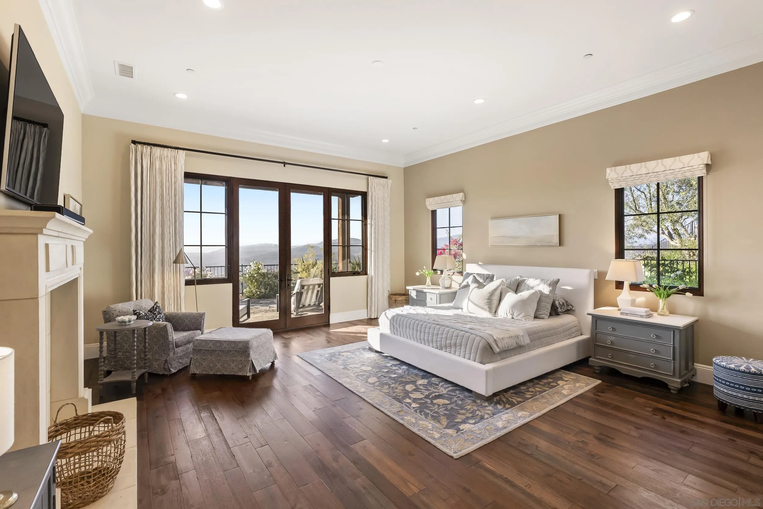 8046 El Cielo Rancho Santa Fe, CA 92067 - Photo 34 of 68 a living room with furniture large windows and a flat screen tv