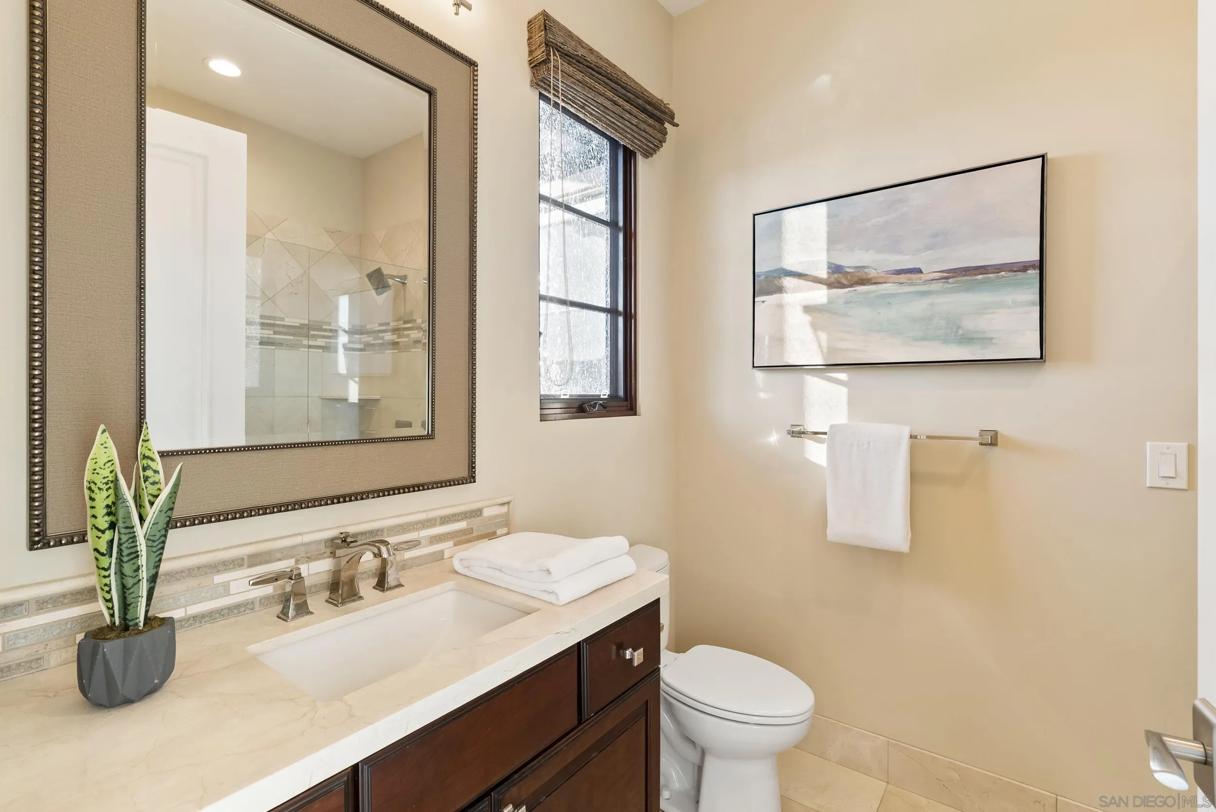8046 El Cielo Rancho Santa Fe, CA 92067 - Photo 42 of 68 a bathroom with a granite countertop sink a toilet and a mirror