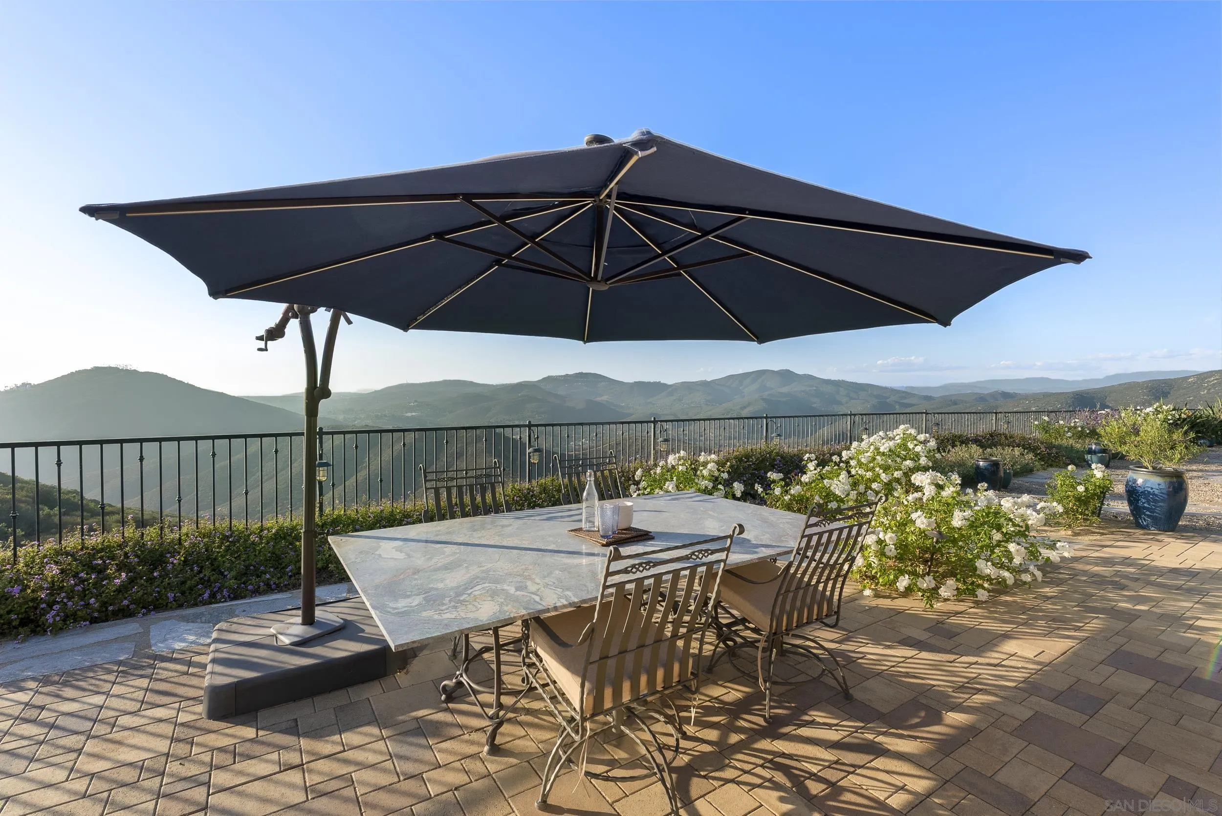 8046 El Cielo Rancho Santa Fe, CA 92067 - Photo 51 of 68 a view of a patio with a table and chairs under an umbrella