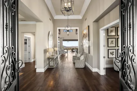a living room with furniture a rug and a floor to ceiling window