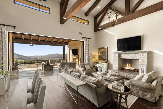 a large kitchen with kitchen island stainless steel appliances a stove a table and chairs