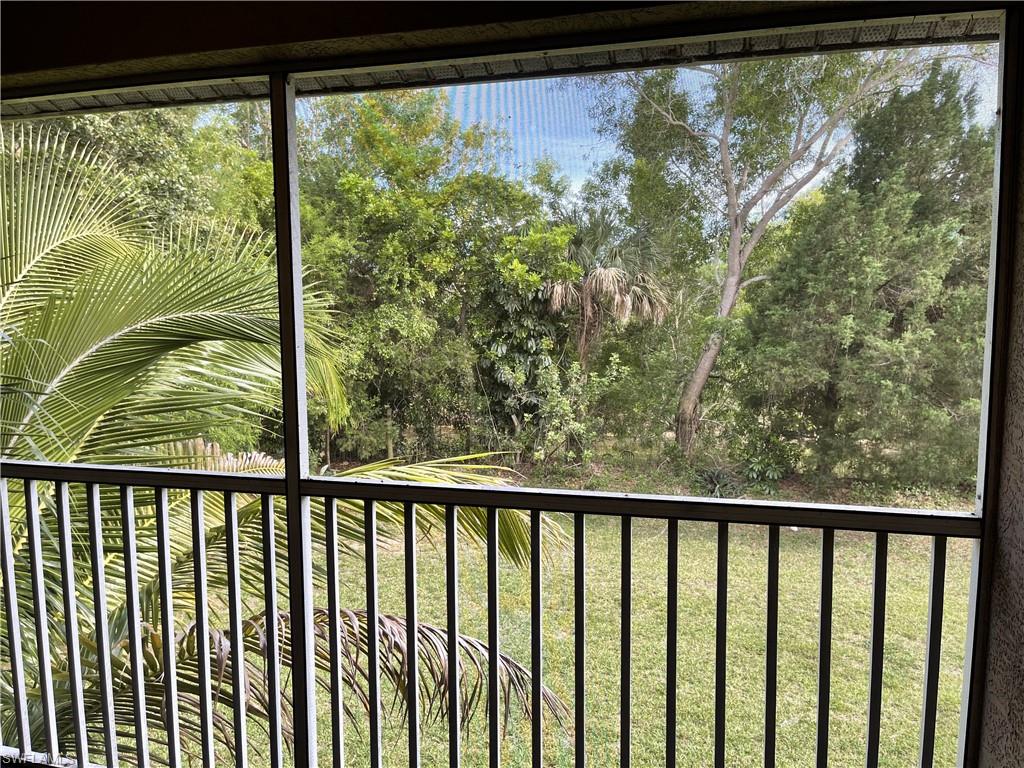5470 16th Place Southwest, Unit 107 Naples, FL 34116 - Photo 1 of 31 a view of a balcony with a yard