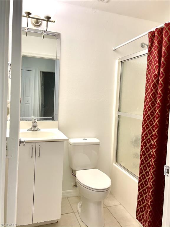 5470 16th Place Southwest, Unit 107 Naples, FL 34116 - Photo 20 of 31 a bathroom with a sink a toilet a mirror and shower