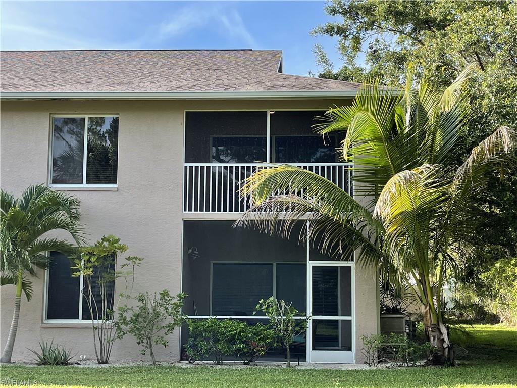 5470 16th Place Southwest, Unit 107 Naples, FL 34116 - Photo 27 of 31 a front view of a house with garden