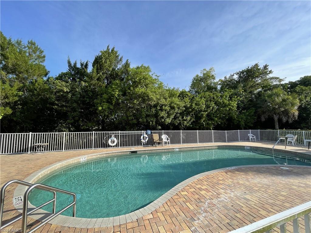 5470 16th Place Southwest, Unit 107 Naples, FL 34116 - Photo 29 of 31 a view of a swimming pool with a backyard