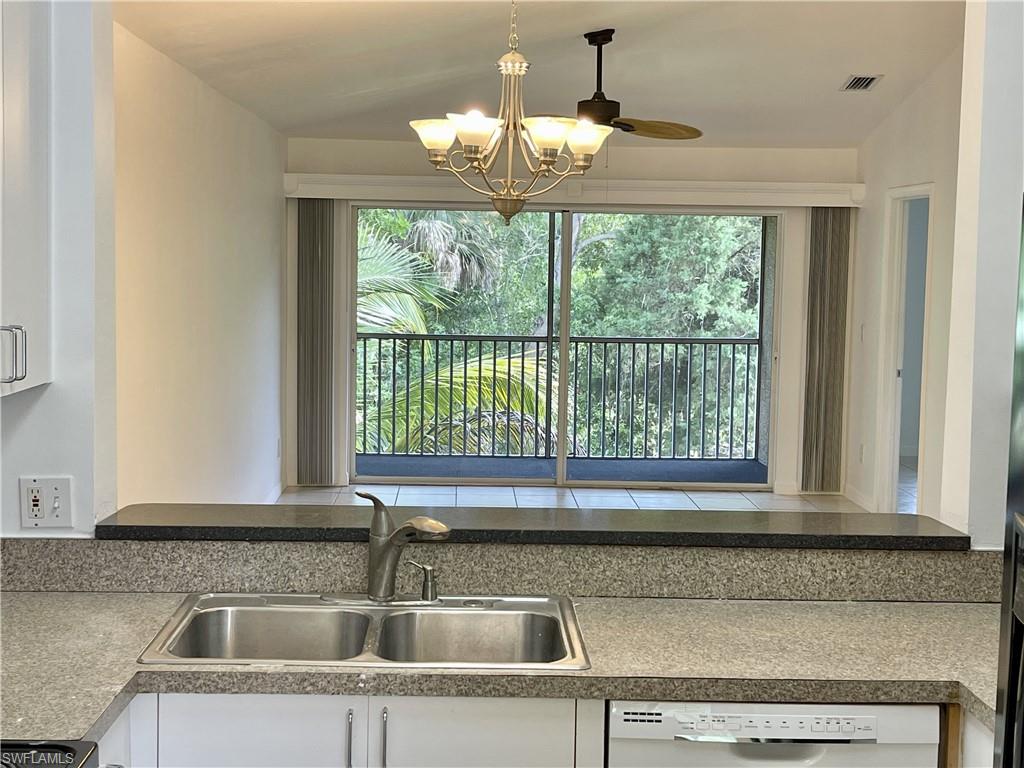 5470 16th Place Southwest, Unit 107 Naples, FL 34116 - Photo 10 of 31 a kitchen with a sink and large window
