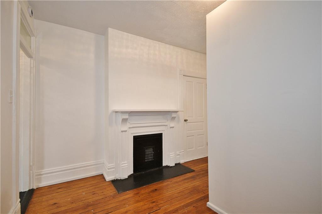 4627 Plummer Street Pittsburgh, PA 15201 - Photo 14 of 29 a view of a livingroom with wooden floor and a fireplace
