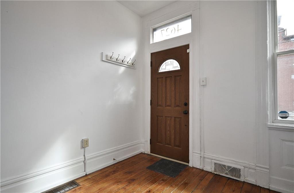 4627 Plummer Street Pittsburgh, PA 15201 - Photo 3 of 29 an empty room with wooden floor cabinet and windows