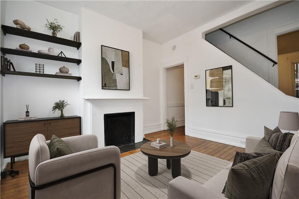 4627 Plummer Street Pittsburgh, PA 15201 - Photo 4 of 29 a living room with furniture and a fireplace