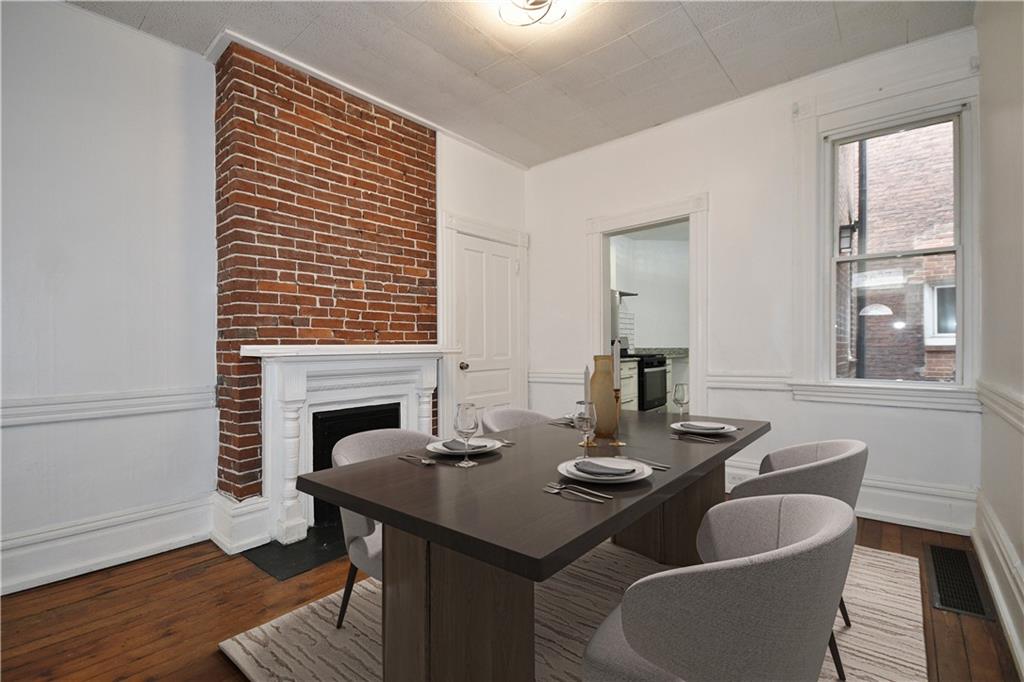 4627 Plummer Street Pittsburgh, PA 15201 - Photo 10 of 29 a view of a dining room with furniture and wooden floor