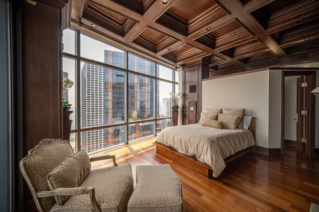 a spacious bedroom with a bed and a television