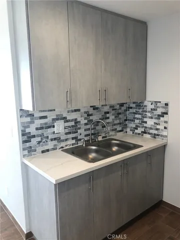 a kitchen with a sink and cabinets
