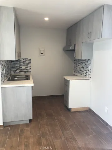 a kitchen with a stove and a white cabinets