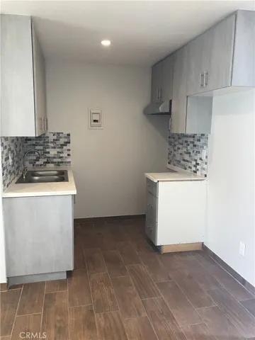 a kitchen with a stove and a white cabinets