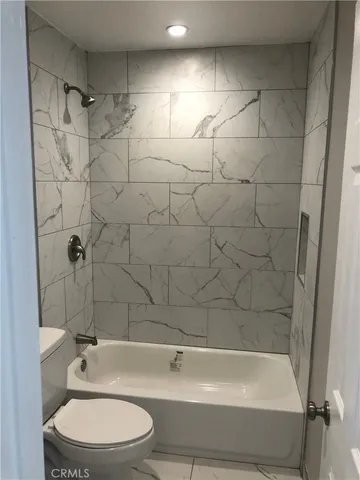 a bathroom with a toilet and a bathtub