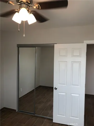 an empty room with wooden floor and cabinet