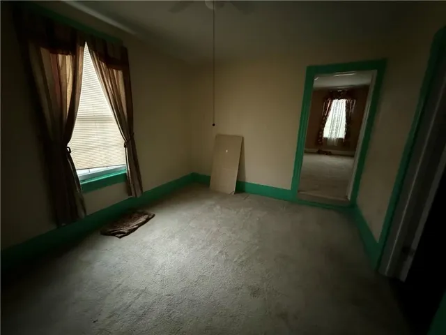 a view of an empty room with a kitchen