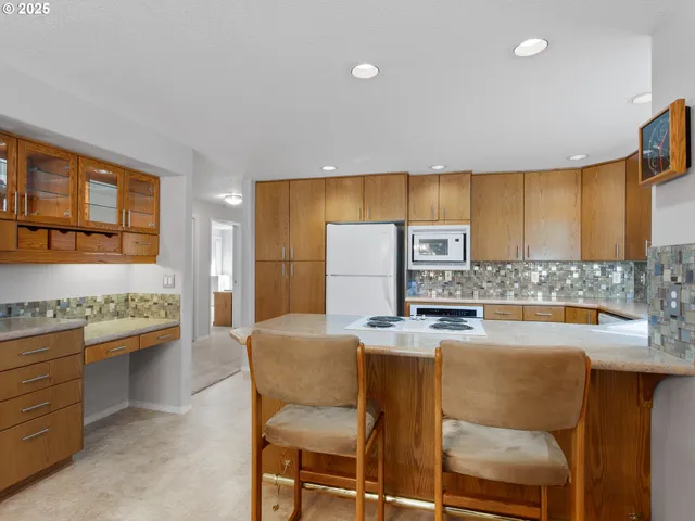 a kitchen with a stove a sink and a refrigerator