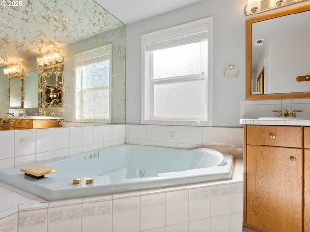 a bathroom with bathtub and window