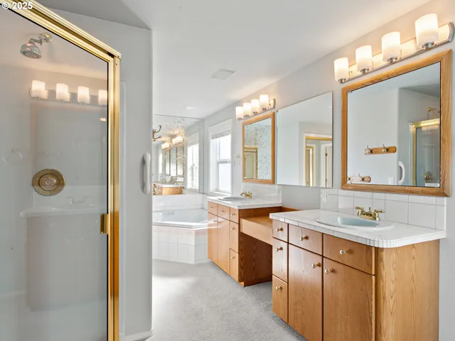 a bathroom with a sink vanity tub and a mirror